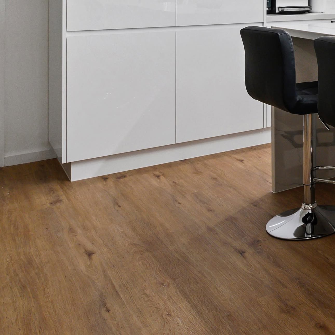 White gloss kitchen cabinetry with timber floor